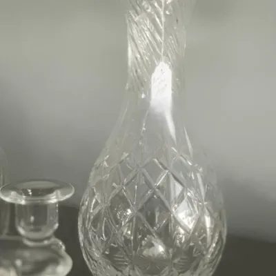 Sale Photo Thumbnail #55: Vintage cut crystal decanter featuring a diamond-patterned body and a spiral-cut neck, shown alongside other glassware.