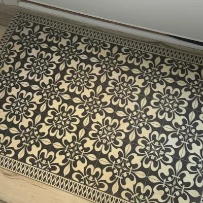 Sale Photo Thumbnail #186: Rectangular floor mat featuring a black and cream Spanish-style tile pattern with a decorative border.