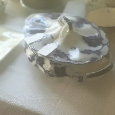 Sale Photo Thumbnail #103: Antique flow blue covered tureen with a floral pattern, scalloped edges, and side handles.