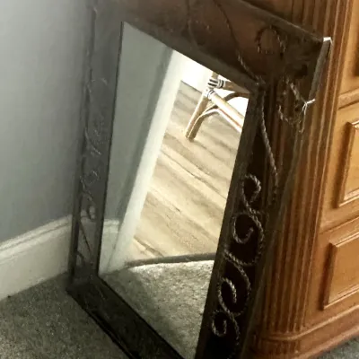 Sale Photo Thumbnail #65: Rectangular wall mirror featuring a dark metal frame with decorative scrollwork and rope-style detailing.