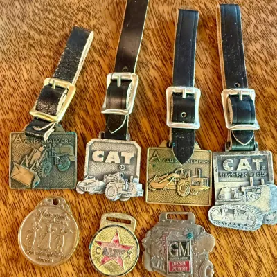 
(7) Vintage Watch Fobs - (4) With Leather Bands - Patten Cat - GM - Allis Chalmers - Monarch Ranges