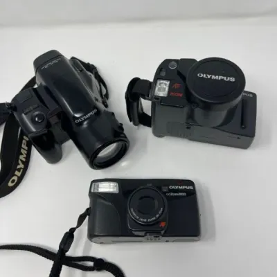 Olympus IS‑2, SuperZoom 300, and Zoom2000 Camera Trio