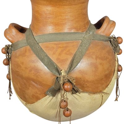 Sale Photo Thumbnail #849: A Two-Handled Earthenware Vessel with Textile and Bead Ornamentation