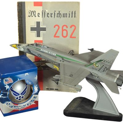 Sale Photo Thumbnail #599: An Assortment of Military Aviation Collectibles Including F/A-18 Hornet Model and Aero Publishers Book