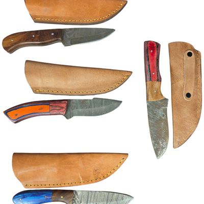 Sale Photo Thumbnail #160: A Collection of Four Fixed Blade Hunting Knives with Damascus Steel Blades and Laminate Handles