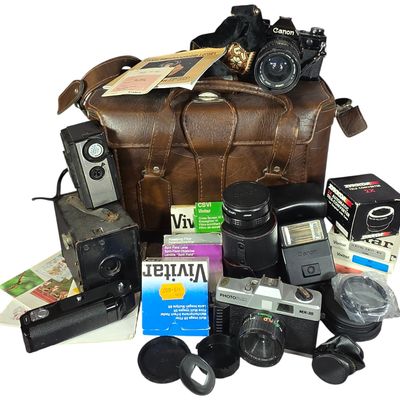 Sale Photo Thumbnail #814: An Assortment of Vintage Cameras and Equipment Including a Canon AE-1 SLR