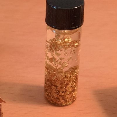 Gold Flakes in Liquid Vial