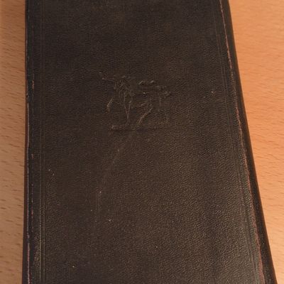Vintage Leather-Bound Pocket Book with Embossed Crest