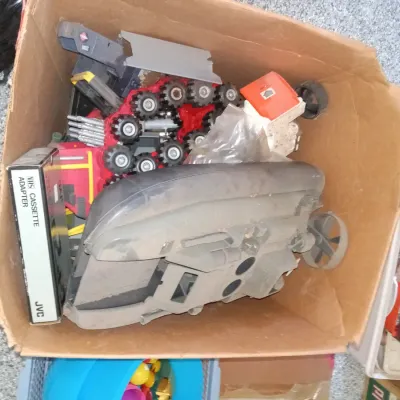 Cardboard box containing vintage G.I. Joe vehicles, including the 1984 Cobra Water Moccasin and the 1985 Cobra S.N.A.K.E. Battle Armor,...