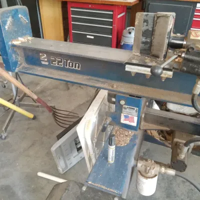 Iron & Oak 22-ton hydraulic log splitter, showing some wear and sawdust from use.