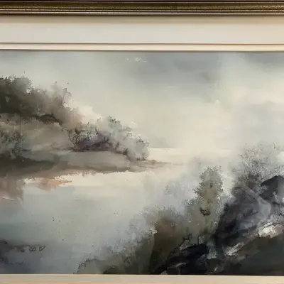 Framed watercolor landscape painting depicting a moody coastal scene with soft grey skies
