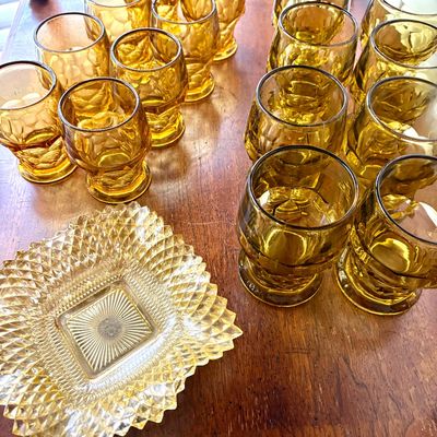 Sale Photo Thumbnail #83: Vintage amber glassware collection, including a variety of footed tumblers and a square diamond-point pattern dish.