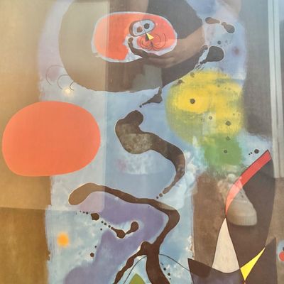 Sale Photo Thumbnail #72: Framed abstract print in the style of Joan Miró, featuring organic shapes, splatters, and a vibrant color palette of blue, orange, yellow, and black.