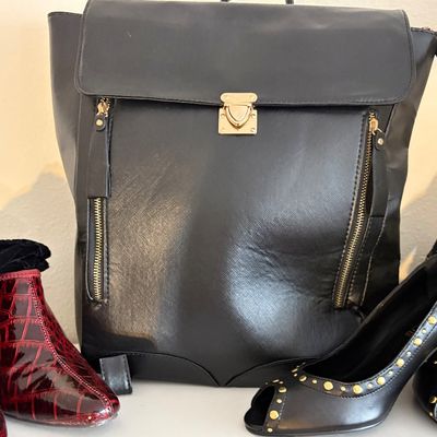 Sale Photo Thumbnail #76: Black faux-leather backpack with gold-tone hardware, displayed alongside a pair of red crocodile-embossed ankle boots and black peep-toe heels with gold stud details.