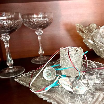 Sale Photo Thumbnail #102: Assorted vintage cut glass and crystal items, including a pair of champagne coupes, a small square tray, a toothpick holder, and decorative crystal prisms.