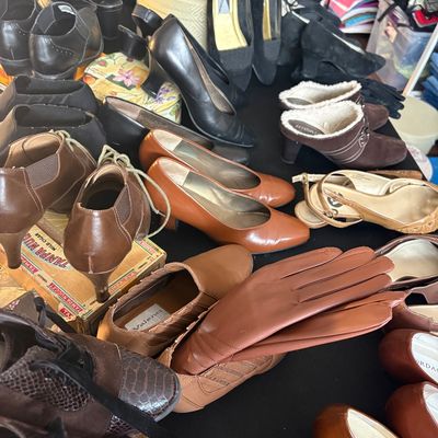 Sale Photo Thumbnail #64: Assortment of vintage women's shoes, including leather pumps, loafers, and ankle boots, displayed alongside a pair of brown leather gloves.