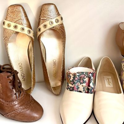 Sale Photo Thumbnail #77: Assorted women's vintage shoes including brown leather lace-up oxfords, gold-toned textured Andiamo flats, cream-colored loafers with floral accents, and tan T-strap heels.