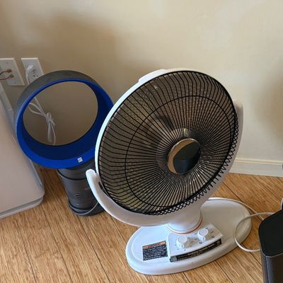 Assorted household electronics including a Hathaspace air purifier, a blue Dyson bladeless fan, a white parabolic space heater, and a...