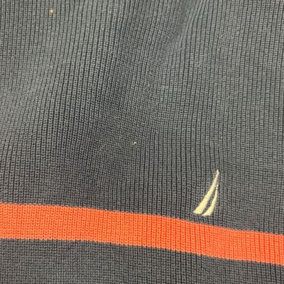 Nautica ribbed knit sweater in navy blue with a horizontal orange stripe and embroidered sailboat logo.