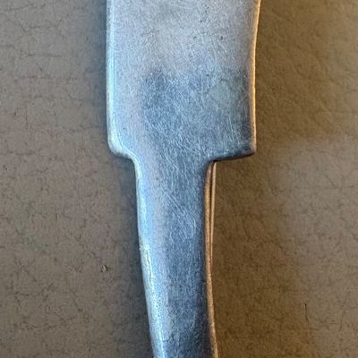 Vintage mid-century modern pewter or silver-tone metal brooch depicting a stylized figure wearing a wide-brimmed hat.