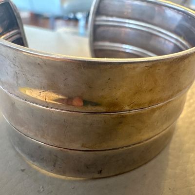 Vintage wide sterling silver cuff bracelet featuring a tiered, ribbed design with a tarnished patina.