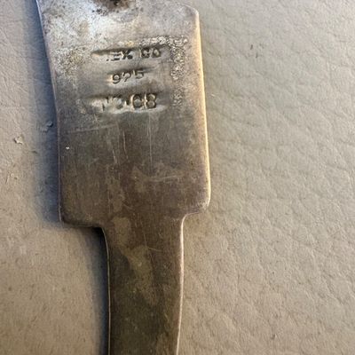 Reverse side of a vintage Mexican sterling silver brooch, showing a pin clasp and stamped hallmarks including "MEXICO",...