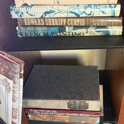 A collection of vintage art and history books, including titles on Auguste Rodin, Impressionism, Edward Sheriff Curtis, and French...