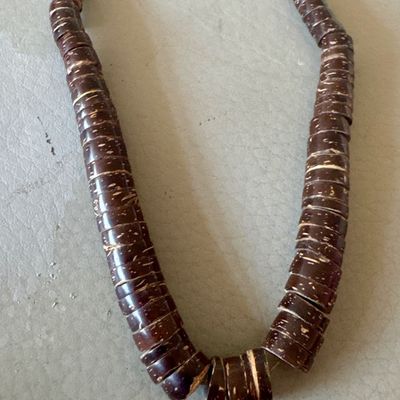 Vintage chunky necklace featuring dark brown, textured wooden or coconut shell disc beads.