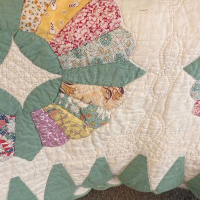 Vintage Dresden Plate pattern quilt featuring colorful floral and patterned fabric wedges with a sage green border and detailed...