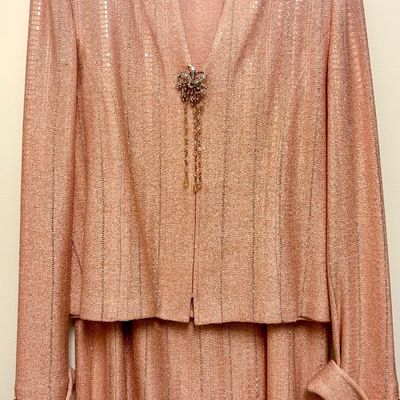 St. John Evening two-piece knit skirt suit in a peach or rose gold metallic shimmer, featuring a structured jacket with a decorative...