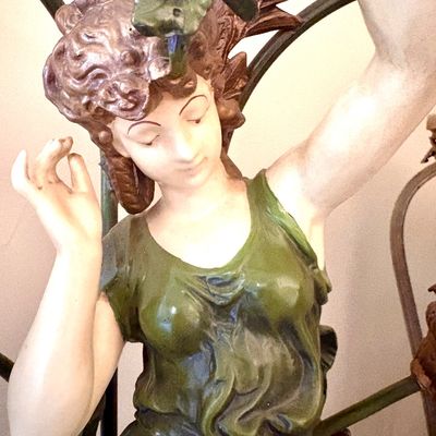 Art Nouveau style painted metal or spelter statue depicting a classical female figure in a green gown, possibly part of a lamp base.