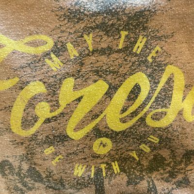 Marmot graphic t-shirt featuring a tree design and the phrase "May the Forest Be With You" in yellow lettering.