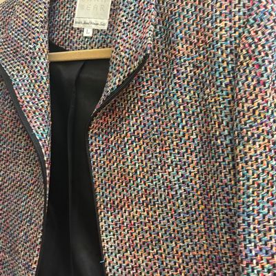 Onna Wear 100% hand-woven silk jacket in a colorful tweed-like pattern, size Large, featuring a black lining and zipper closure.