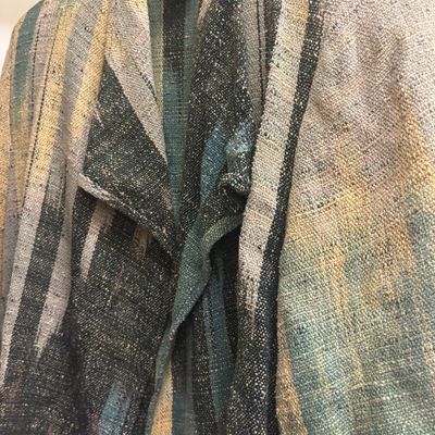 Candiss Cole hand-woven silk jacket featuring a draped collar and a textured, multi-colored stripe pattern in earth tones.
