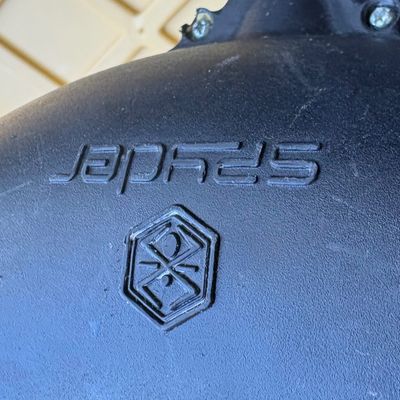 Spyder brand black molded plastic component, showing the embossed logo and brand name.