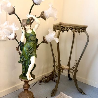 Art Nouveau style figural floor lamp featuring a woman in a green dress with five frosted glass tulip shades, paired with an ornate brass...