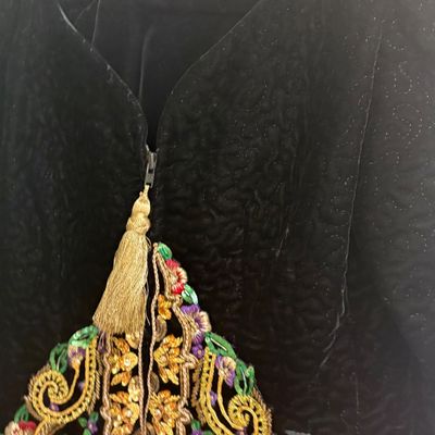 Vintage black velvet jacket by Teri Jon Nites, featuring a textured pattern, a gold tassel zipper pull, and colorful floral embroidery...