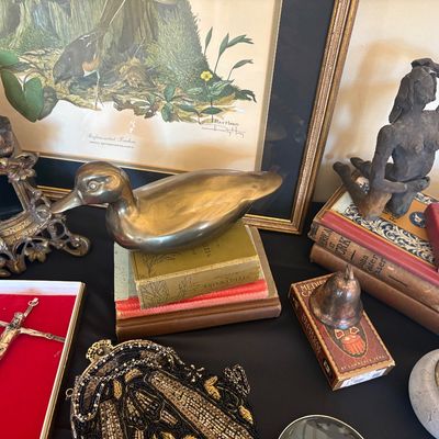 Assortment of vintage collectibles, including a brass duck decoy figurine, a beaded evening bag, a crucifix in a red velvet box, old...
