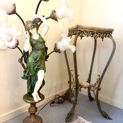 Art Nouveau style figural floor lamp featuring a woman in a green dress with frosted glass tulip shades, alongside an ornate brass and...