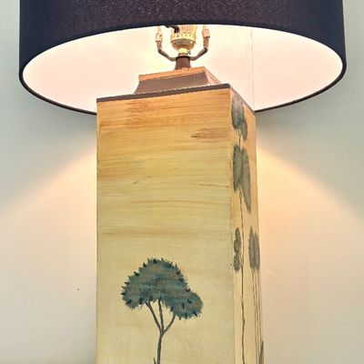 Vintage hand-painted ceramic table lamp featuring a stylized landscape with trees on a rectangular base, topped with a modern black drum...