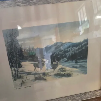 Sale Photo Thumbnail #12: Framed and matted print titled "Deer Country in Winter," depicting two deer in a snowy mountain landscape, housed in a rustic gray-washed wood frame.