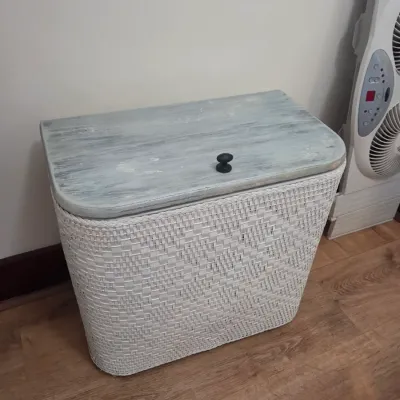 Sale Photo Thumbnail #55: Vintage white woven wicker laundry hamper featuring a distressed, light blue painted wooden lid with a black knob.