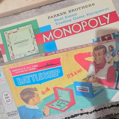 Sale Photo Thumbnail #6: Vintage board games including a Milton Bradley Battleship game and a Parker Brothers Monopoly game, showing some wear on the boxes.