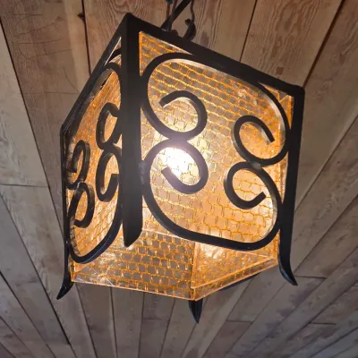 Sale Photo Thumbnail #16: Vintage Spanish Revival style wrought iron pendant light with amber textured glass panels, circa 1970s.