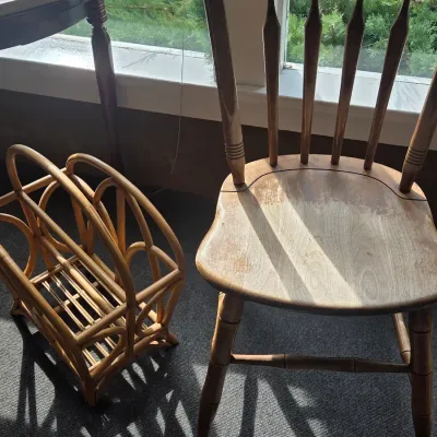 Sale Photo Thumbnail #20: Vintage bentwood bamboo-style magazine rack alongside a wooden spindle-back dining chair, showing some wear to the finish.