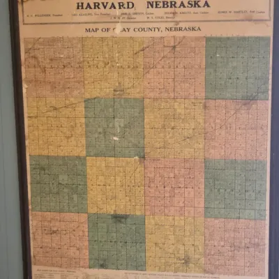 Sale Photo Thumbnail #42: Vintage framed map of Clay County, Nebraska, issued by The Harvard State Bank, showing some age-related wear and discoloration.