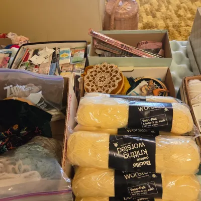 Sale Photo Thumbnail #50: Assortment of vintage sewing and knitting supplies, including Bucilla deluxe worsted knitting yarn in yellow, crochet doilies, bias tape, and embroidery hoops.