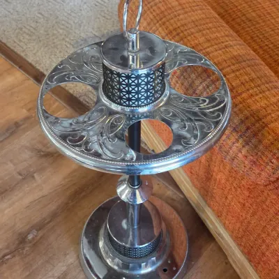 Sale Photo Thumbnail #15: Vintage mid-century chrome smoking stand with an ornate scrollwork tray, integrated ashtray, and carrying handle.