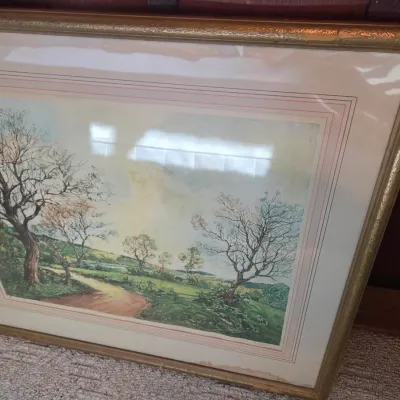 Sale Photo Thumbnail #77: Framed landscape print depicting a winding path through a grassy field with bare trees, presented under glass in a gilded frame with a multi-layered mat.