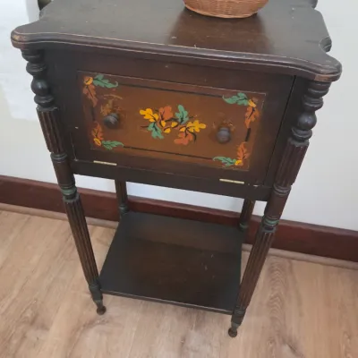Sale Photo Thumbnail #57: Vintage dark wood telephone table or nightstand featuring a hand-painted floral and leaf motif on the drop-front cabinet door, turned legs, and a lower shelf.